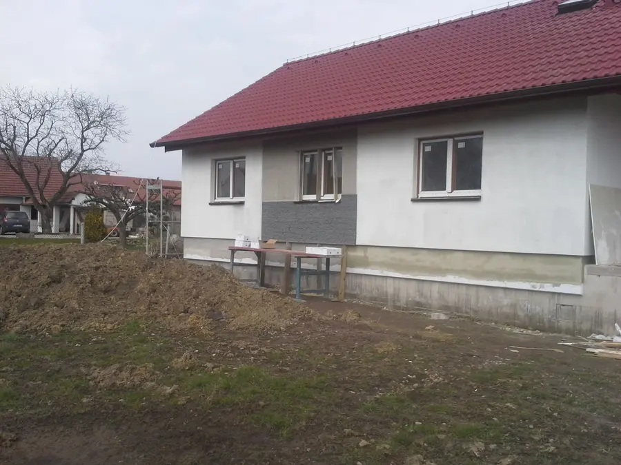 Hotová bílá fasáda s&nbsp;antracitovým pásem, Nové Dvory